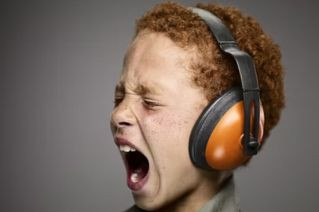 child screaming with headphones on