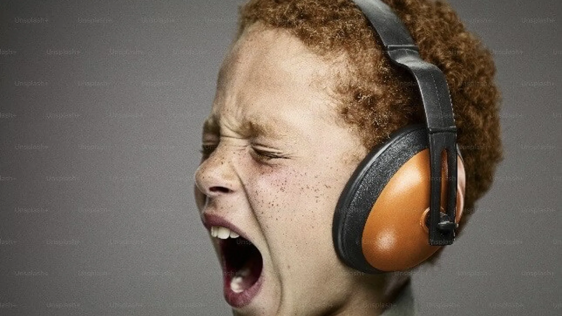 Screaming kid with ear defenders
