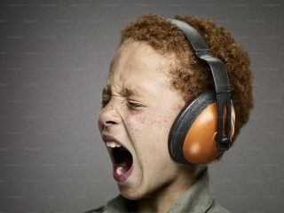 Screaming kid with ear defenders