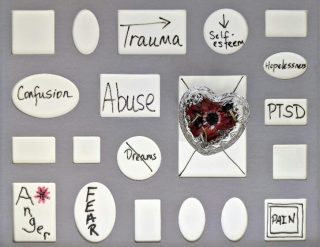 A board with various emotions surrounding trauma written and pinned