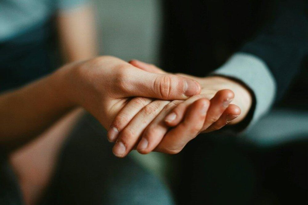 Two hands clasped together